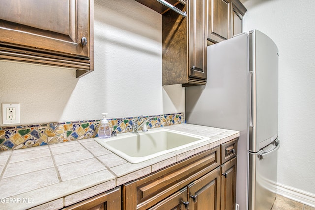 1348 Franklin Wind Place, El Paso, TX 79912 - kitchen featuring tile countertops and freestanding refrigerator