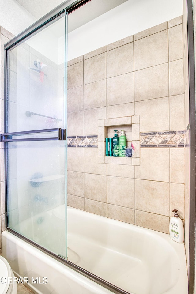 1348 Franklin Wind Place, El Paso, TX 79912 - full bath with shower / bath combination with glass door and toilet