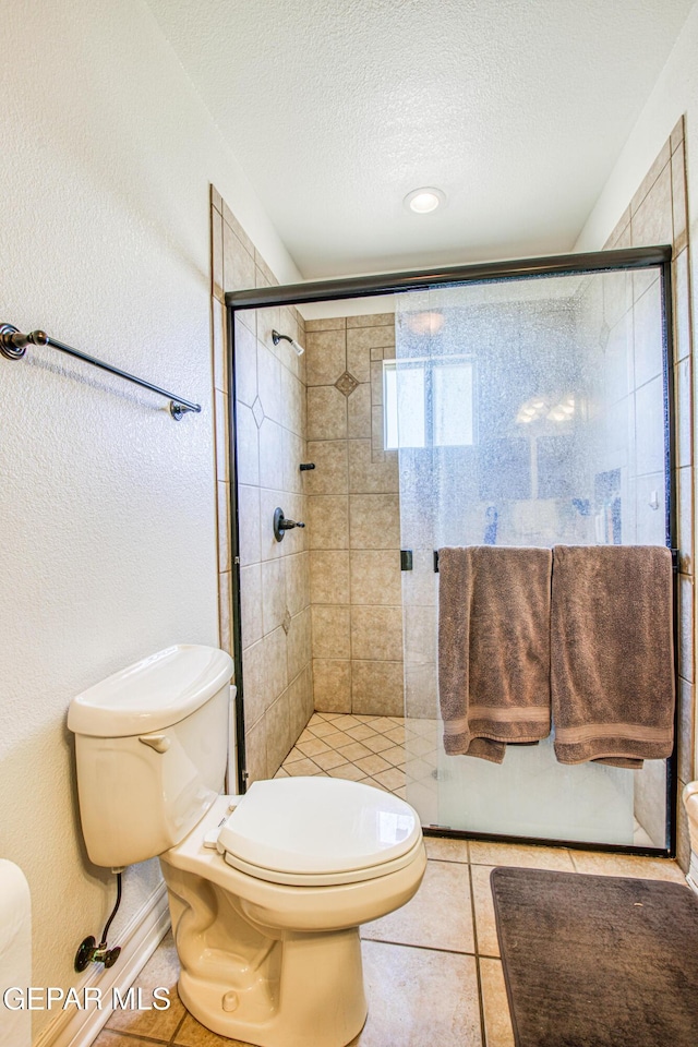 1348 Franklin Wind Place, El Paso, TX 79912 - bathroom with a shower stall, a textured ceiling, and tile patterned floors