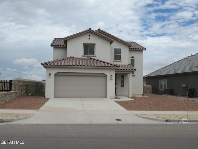 205 Staffs Way, El Paso, TX 79928 - mediterranean / spanish house with concrete driveway, stucco siding, a tiled roof, and an attached garage