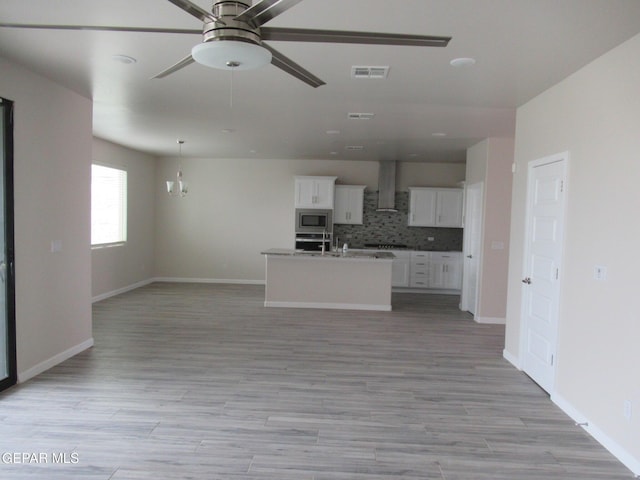 205 Staffs Way, El Paso, TX 79928 - kitchen with appliances with stainless steel finishes, open floor plan, a ceiling fan, and wall chimney exhaust hood