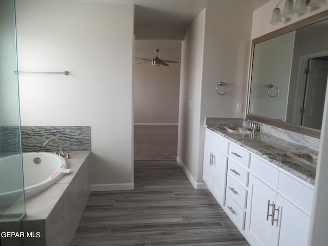 205 Staffs Way, El Paso, TX 79928 - bathroom with vanity, ceiling fan, a garden tub, and wood finished floors