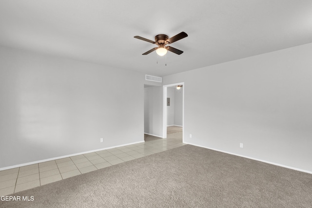 8936 Mount Rushmore Ln, El Paso, TX 79904 - tiled empty room featuring a ceiling fan and carpet flooring