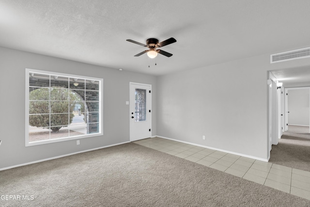 8936 Mount Rushmore Ln, El Paso, TX 79904 - empty room featuring a ceiling fan, carpet floors, and tile patterned flooring
