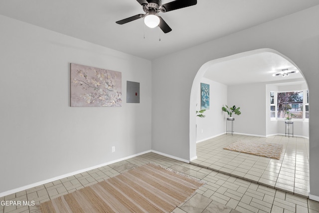 8936 Mount Rushmore Ln, El Paso, TX 79904 - tiled spare room with arched walkways, electric panel, and a ceiling fan