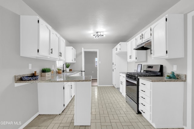 8936 Mount Rushmore Ln, El Paso, TX 79904 - kitchen with stainless steel gas range, under cabinet range hood, white cabinets, and light stone countertops