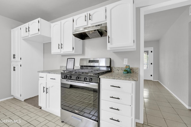 8936 Mount Rushmore Ln, El Paso, TX 79904 - kitchen with stainless steel gas range, under cabinet range hood, white cabinets, and light stone counters