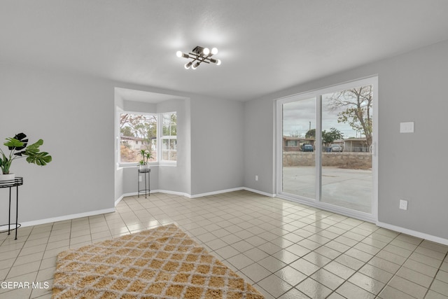 8936 Mount Rushmore Ln, El Paso, TX 79904 - empty room with tile patterned flooring and a chandelier