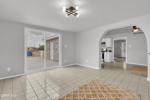 8936 Mount Rushmore Ln, El Paso, TX 79904 - spare room with arched walkways, a chandelier, light tile patterned floors, and a ceiling fan