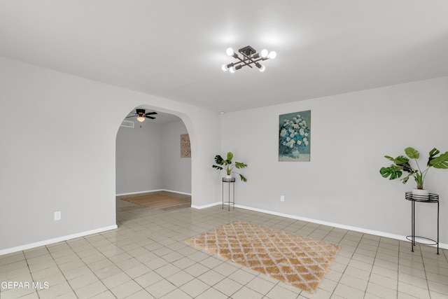 8936 Mount Rushmore Ln, El Paso, TX 79904 - empty room featuring arched walkways, a chandelier, light tile patterned floors, and a ceiling fan