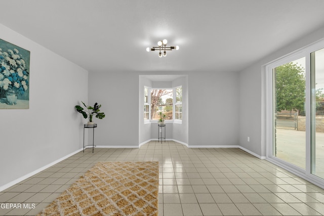 8936 Mount Rushmore Ln, El Paso, TX 79904 - tiled empty room featuring a chandelier and baseboards
