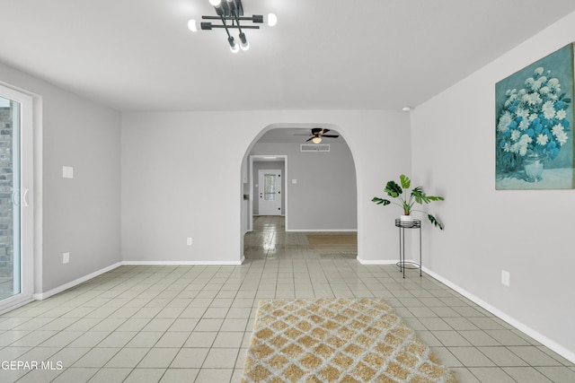 8936 Mount Rushmore Ln, El Paso, TX 79904 - spare room with ceiling fan, tile patterned floors, and arched walkways