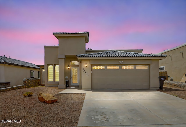 13675 Everingham St, El Paso, TX 79928 - mediterranean / spanish-style home with a tiled roof, concrete driveway, a garage, and stucco siding