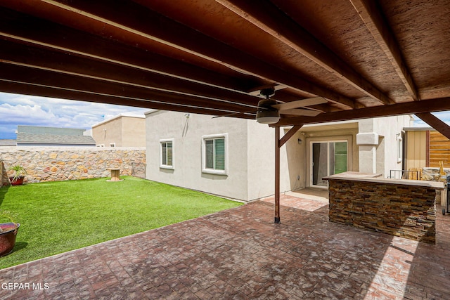 13675 Everingham St, El Paso, TX 79928 - fenced backyard with ceiling fan and a patio area