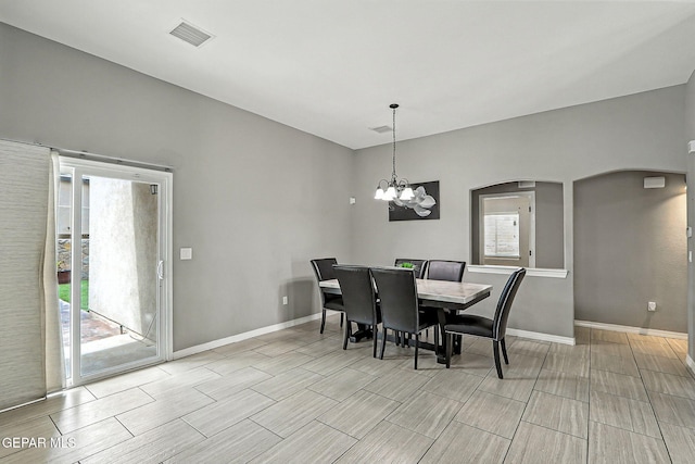 13675 Everingham St, El Paso, TX 79928 - dining area with arched walkways, a chandelier, and wood finish floors