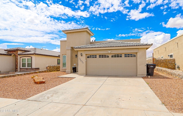 13675 Everingham St, El Paso, TX 79928 - mediterranean / spanish home with a tile roof, stucco siding, driveway, and an attached garage