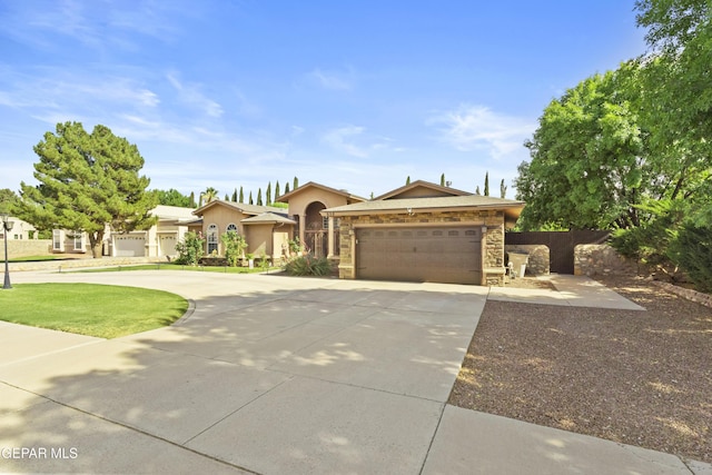658 Sara Lynn Ct, El Paso, TX 79932 - view of front facade featuring concrete driveway, an attached garage, stucco siding, and stone siding