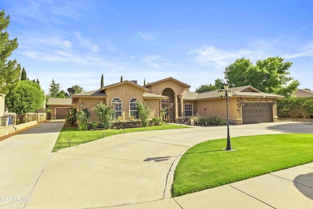 658 Sara Lynn Ct, El Paso, TX 79932 - view of front of house with stucco siding, driveway, an attached garage, and stone siding