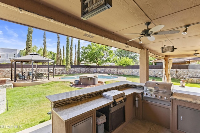 658 Sara Lynn Ct, El Paso, TX 79932 - fenced backyard featuring a gazebo, an outdoor kitchen, a ceiling fan, and a patio area
