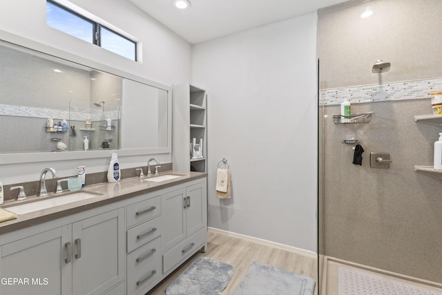 658 Sara Lynn Ct, El Paso, TX 79932 - full bathroom with a tile shower, wood finished floors, and double vanity