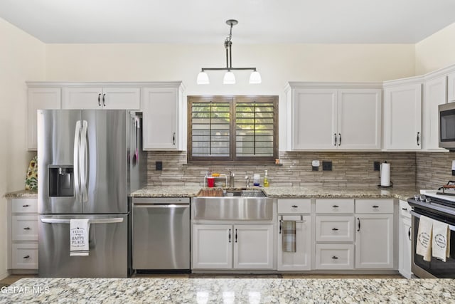 658 Sara Lynn Ct, El Paso, TX 79932 - kitchen with stainless steel appliances, white cabinets, backsplash, and light stone counters