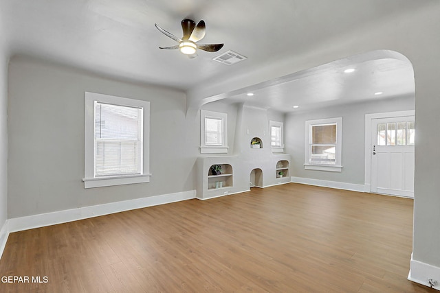 3413 Monroe Ave, El Paso, TX 79930 - unfurnished living room with a ceiling fan, wood finished floors, arched walkways, and recessed lighting