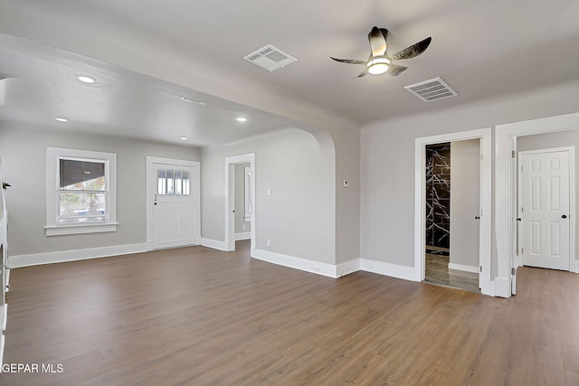 3413 Monroe Ave, El Paso, TX 79930 - unfurnished living room featuring arched walkways, ceiling fan, dark wood finished floors, and recessed lighting