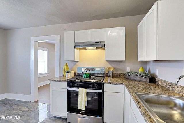 3413 Monroe Ave, El Paso, TX 79930 - kitchen featuring gas range, ventilation hood, and white cabinetry