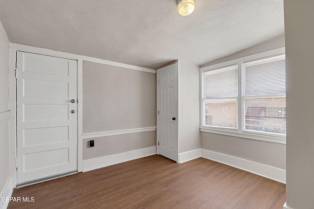 3413 Monroe Ave, El Paso, TX 79930 - unfurnished room with wood finished floors, a textured ceiling, and a smoke detector