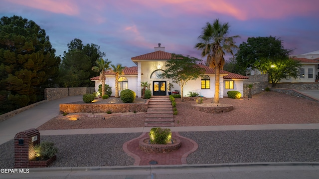1386 Loma Verde Dr, El Paso, TX 79936 - mediterranean / spanish-style house featuring driveway, a tiled roof, french doors, stucco siding, and a chimney