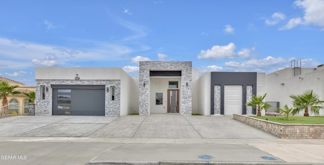 11345 Patricia Ave, El Paso, TX 79936 - modern home featuring stone siding, concrete driveway, an attached garage, and stucco siding