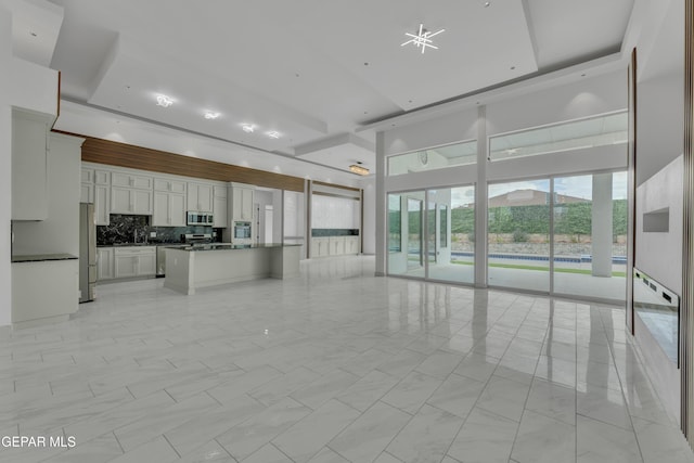 11345 Patricia Ave, El Paso, TX 79936 - unfurnished living room featuring a sink and a towering ceiling