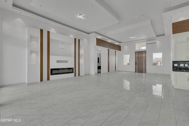 11345 Patricia Ave, El Paso, TX 79936 - unfurnished living room featuring a tray ceiling, a wall unit AC, and light marble finish floors