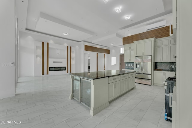 11345 Patricia Ave, El Paso, TX 79936 - kitchen with stainless steel fridge with ice dispenser, range, a wall mounted air conditioner, and light marble finish flooring