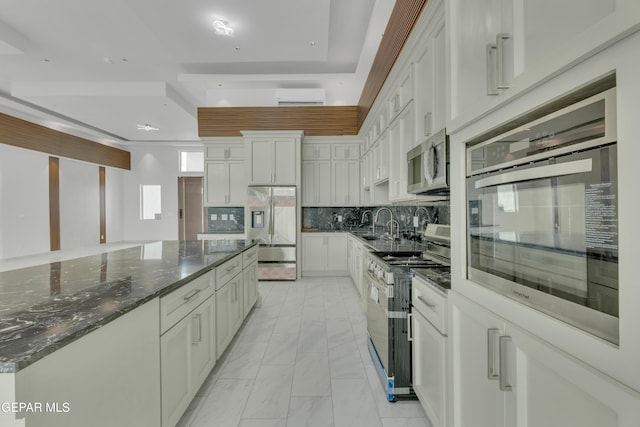 11345 Patricia Ave, El Paso, TX 79936 - kitchen featuring stainless steel appliances, light marble finish flooring, white cabinets, and tasteful backsplash