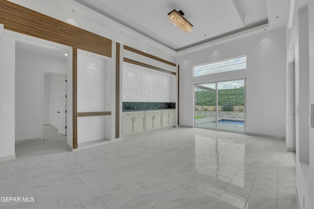 11345 Patricia Ave, El Paso, TX 79936 - unfurnished room with a towering ceiling and a raised ceiling