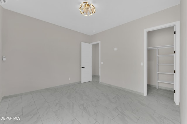 11345 Patricia Ave, El Paso, TX 79936 - unfurnished bedroom featuring a walk in closet and light marble finish floors