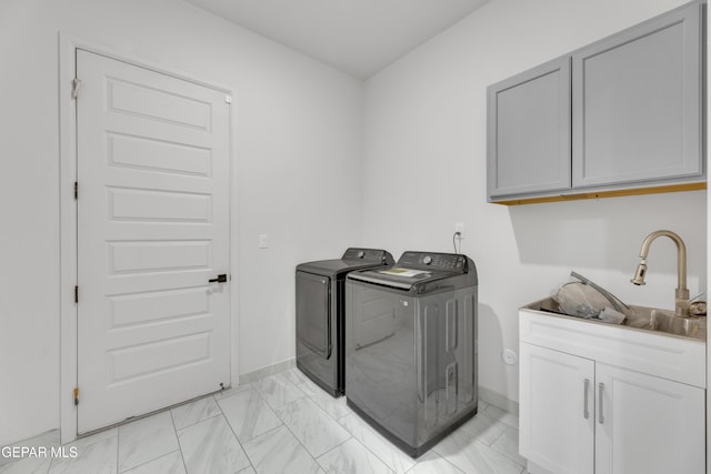 11345 Patricia Ave, El Paso, TX 79936 - laundry area with washer and clothes dryer, cabinet space, and light marble finish floors