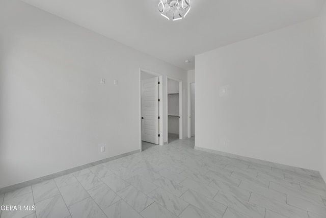 11345 Patricia Ave, El Paso, TX 79936 - empty room with a chandelier and light marble finish floors
