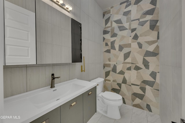 11345 Patricia Ave, El Paso, TX 79936 - bathroom featuring tile walls, vanity, and marble look tile flooring