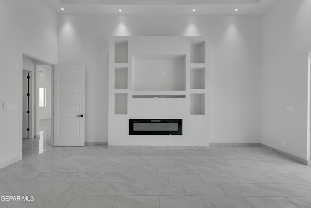 11345 Patricia Ave, El Paso, TX 79936 - unfurnished living room with a glass covered fireplace, recessed lighting, and marble look tile flooring