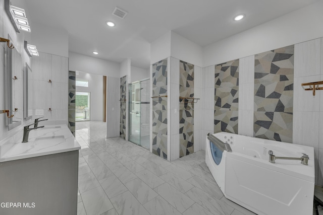 11345 Patricia Ave, El Paso, TX 79936 - bathroom with double vanity, a tub with jets, a shower stall, recessed lighting, and marble finish floors
