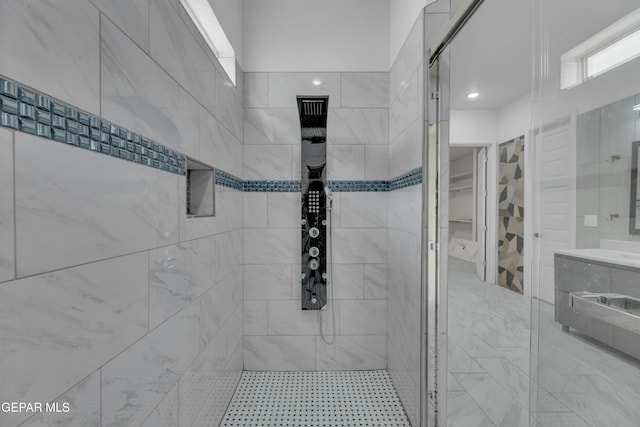 11345 Patricia Ave, El Paso, TX 79936 - bathroom featuring a tile shower, vanity, and a spacious closet