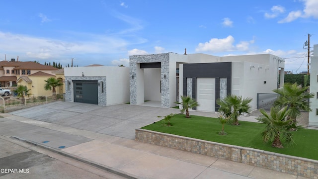 11345 Patricia Ave, El Paso, TX 79936 - contemporary home with stucco siding, concrete driveway, an attached garage, and stone siding