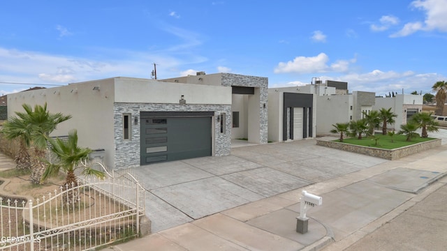11345 Patricia Ave, El Paso, TX 79936 - contemporary house with stucco siding, concrete driveway, an attached garage, and stone siding