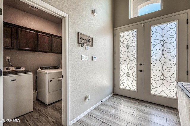 12616 Blazing Star Dr, El Paso, TX 79928 - laundry area with washing machine and clothes dryer, cabinet space, french doors, wood finish floors, and a textured wall