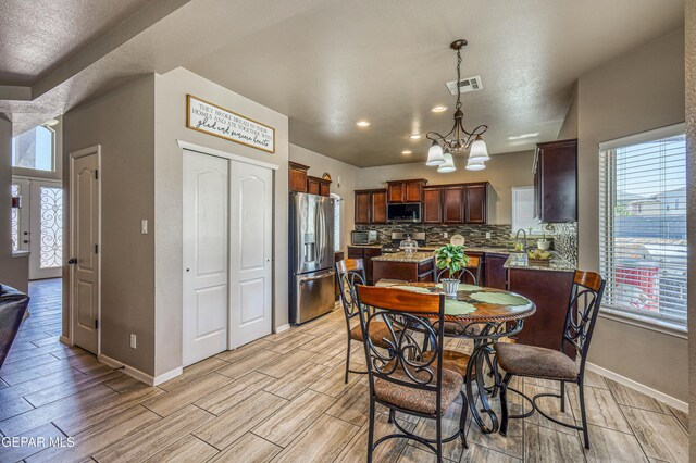 12616 Blazing Star Dr, El Paso, TX 79928 - dining space with a chandelier, wood finish floors, and recessed lighting