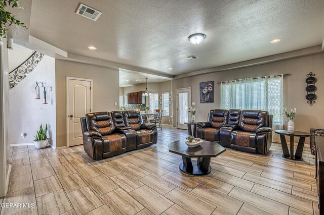 12616 Blazing Star Dr, El Paso, TX 79928 - living room featuring wood tiled floors, a textured ceiling, and recessed lighting