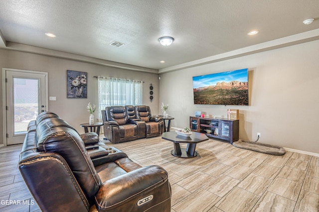 12616 Blazing Star Dr, El Paso, TX 79928 - living room with wood tiled floors, a textured ceiling, and recessed lighting