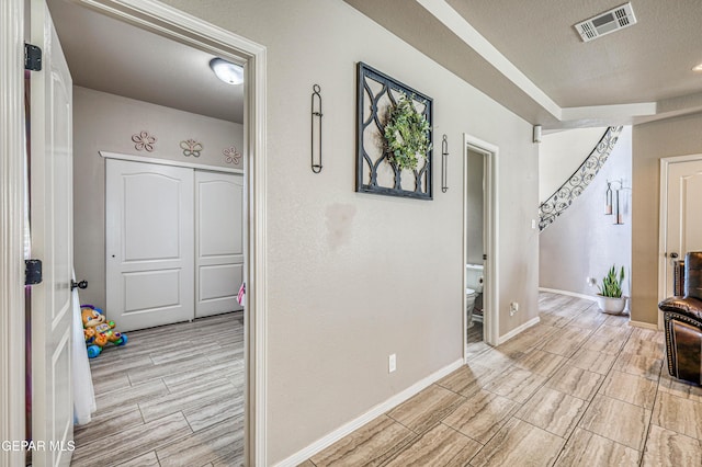 12616 Blazing Star Dr, El Paso, TX 79928 - hall featuring wood tiled floors and a textured ceiling